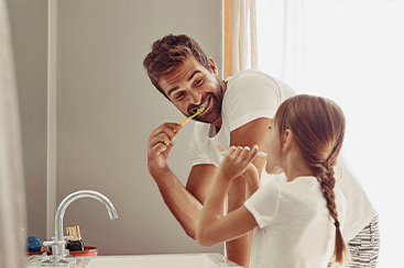 dad and daughter brushing teeth in fort smith